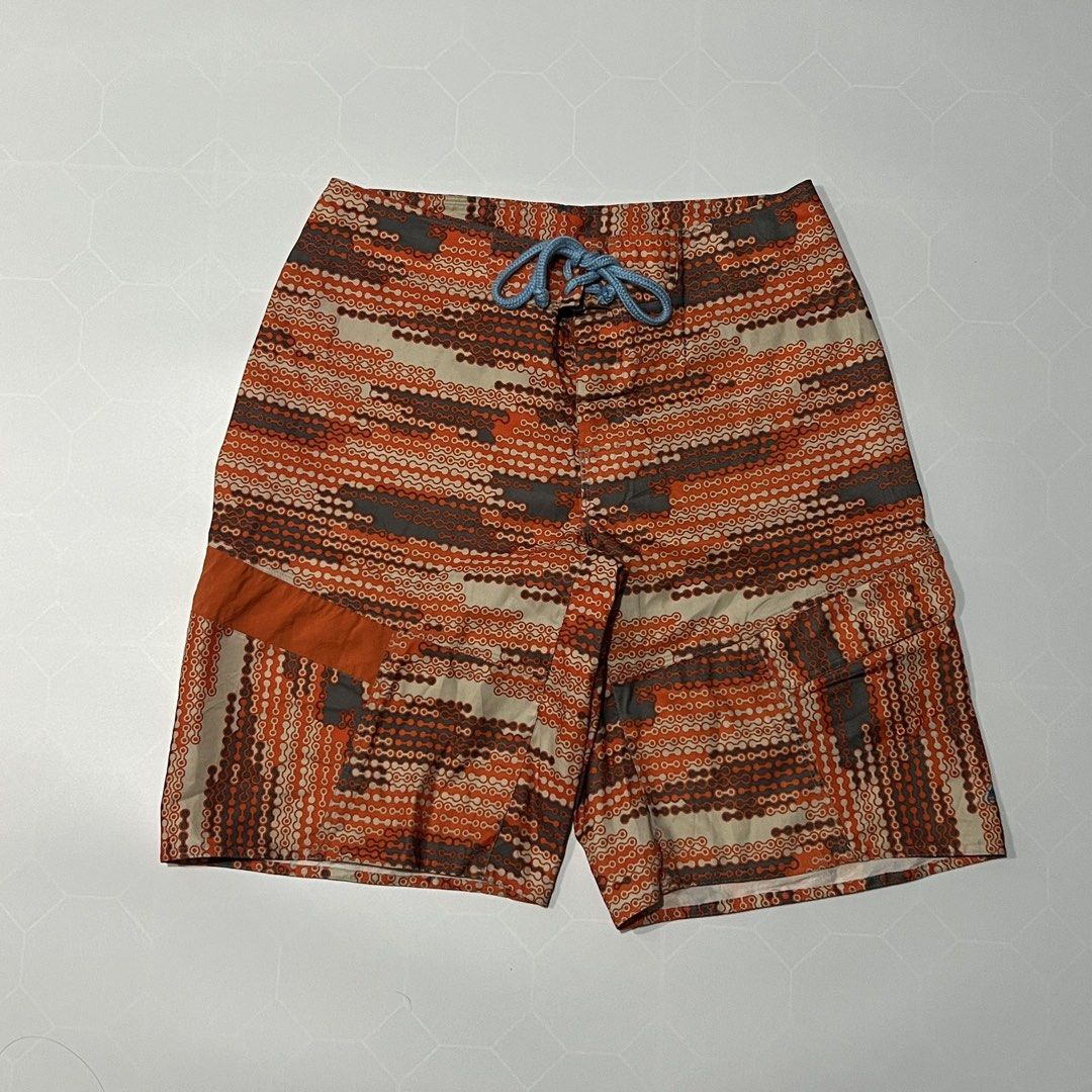 Nike ACG Orange Chainlink Board Shorts (Category: Swim Trunks & Board Shorts) located in Caloocan City. Submitted by lostarchive_55 (Listing ID 1465917433, Image 1). Description: - Brand: Nike ACG - Style: Men's board shorts with an orange and grey chainlink pattern - Size: 34 - Material: 92% polyester, 8% polyurethane (Made in India) - Features: Light blue waist drawstring and a functional cargo pocket on the right leg - Condition: Clean inside 