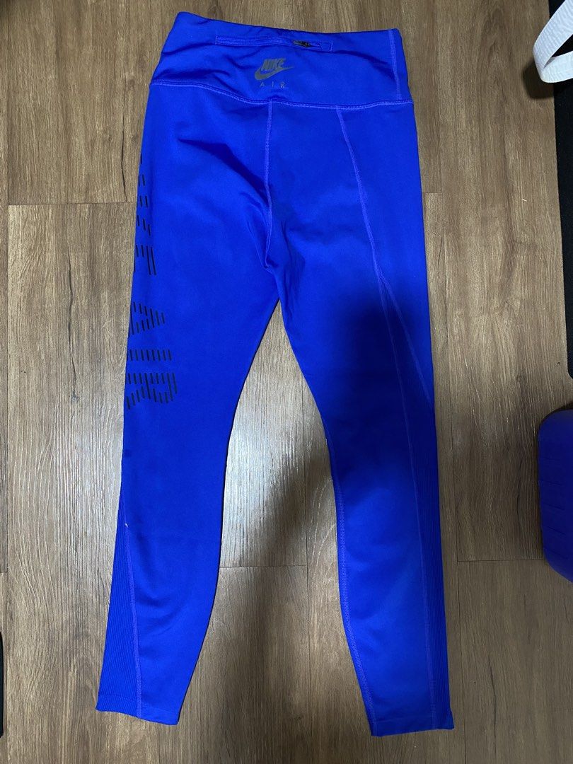Nike Air Blue Running Leggings (Category: Activewear) located in Candon. Submitted by thriftyelegance (Listing ID 1465922086, Image 2). Description: - Brand: Nike Air - Color: Bright royal blue with black stripe graphics - Waist: High-waist design with a convenient small zip pocket in the back waistband - Features: Ribbed side panel details on the lower legs - Material: Stretchy, supportive, and high-quality - Best for: Workouts, gym sessions, ru