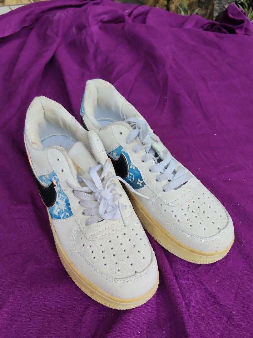 Nike Air Force 1 Custom Blue LV Monogram Size 7.5 (Category: Sneakers) located in Caloocan City. Submitted by kaymatias (Listing ID 1465909884, Image 1). Description: - Model: Custom Nike Air Force 1 - Size: US 7.5 / EUR 41 / JAP 25.5 - Details: White leather upper, blue Louis Vuitton monogram accents on side panels and heel tab, classic black swoosh overlays - Condition: Soles show visible yellowing from age and wear, underside treads have dirt 
