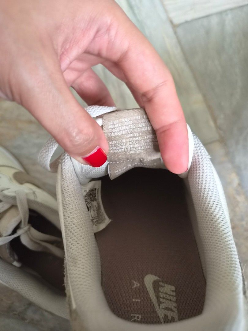 Nike Air Force 1 Low (Category: Sneakers) located in Quezon City. Submitted by mimi0024 (Listing ID 1465802217, Image 3). Description: - Brand/Model: Nike low-top sneakers - Colorway: White leather with beige suede accents and gum outsoles - Size: US 9.5 / UK 8.5 / EUR 43 / CM 27.5 - Features: Standard lace-up closure and embroidered Nike Air branding on heel tabs - Condition: General wear on uppers and midsoles with visible creasing.