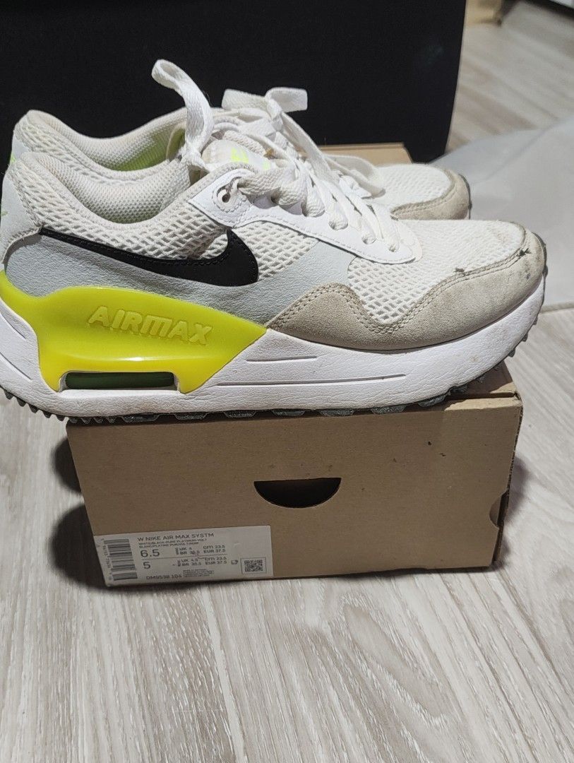 Nike Air Max White (Category: Sneakers) located in Malabon City. Submitted by mikeshisho (Listing ID 1465823710, Image 3). Description: - Brand: Nike Air Max - Colorway: White, Black, and Neon Yellow Volt - Size: Women's size 6.5 - Material: Mesh and suede upper panels - Cushioning: Classic visible Air Max heel unit - Condition/Inclusions: Comes with original shoebox - Style: Great everyday kicks with a bold pop of color.