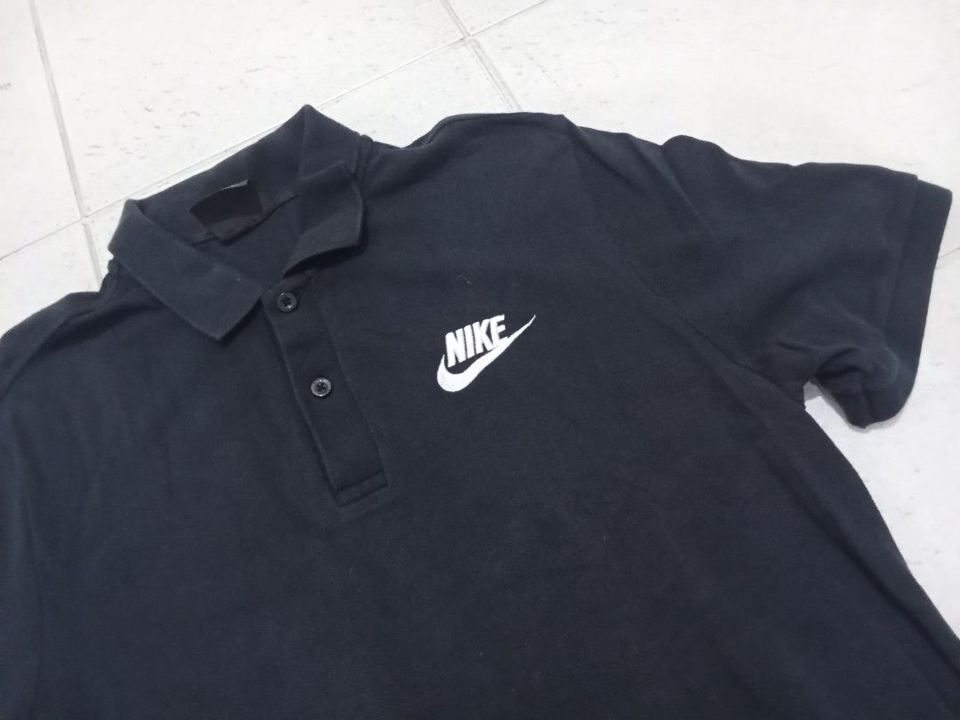Nike Black Polo Shirt Size L (Category: Tshirts & Polo Shirts ) located in Manila. Submitted by kitkathrift (Listing ID 1465870163, Image 2). Description: - Brand: Nike - Style: Classic polo shirt - Color: Solid black with crisp white embroidered logo - Size: Large - Details: Standard collar with 2 buttons, short sleeves, lightweight material - Condition: Great for casual wear or sports.