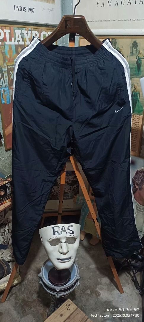 Nike black track pants with white stripes (Category: Joggers) located in Santo Tomas. Submitted by pickers_corner (Listing ID 1465763544, Image 1). Description: vintage NIKE track pants size M w28-32 L40 h9 very good condition no holes no stain - Color: Black with white side stripes - Material: Lightweight, nylon-like fabric - Fit: Elastic waistband with adjustable drawstring - Details: Embroidered white Nike swoosh near the left pocket, Japanese