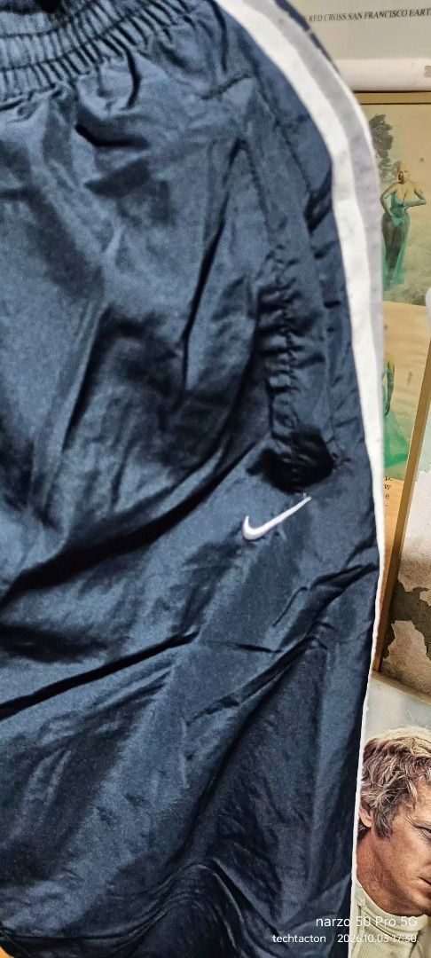 Nike black track pants with white stripes (Category: Joggers) located in Santo Tomas. Submitted by pickers_corner (Listing ID 1465763544, Image 2). Description: vintage NIKE track pants size M w28-32 L40 h9 very good condition no holes no stain - Color: Black with white side stripes - Material: Lightweight, nylon-like fabric - Fit: Elastic waistband with adjustable drawstring - Details: Embroidered white Nike swoosh near the left pocket, Japanese