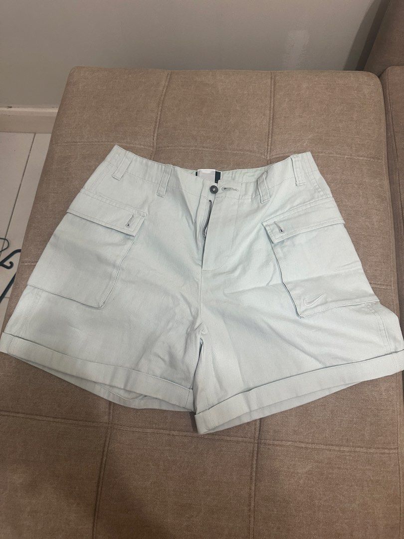 Nike Cargo Shorts Light Green Size 32 (Category: Shorts) located in Manila. Submitted by royal_vintage_thriftshop (Listing ID 1465849950, Image 2). Description: - Brand: Nike - Style: Cargo shorts with cuffed hems - Size: 32 - Color: Light green - Material: 100% heavy cotton canvas - Features: Multiple utility pockets on front and back, button fly closure, embroidered Nike swoosh on lower left pocket - Condition: Excellent.