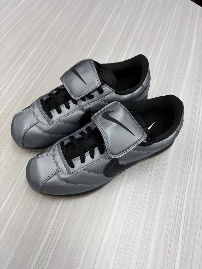 Nike Cortez SE Metallic Cool Grey / Black 72 (Category: Sneakers) located in Makati City. Submitted by sonnybau (Listing ID 1465839507, Image 1). Description: - Colorway: Metallic silver upper with black swoosh, laces, and outsole - Design: Distinct fold-over lace cover with embossed Nike branding and number 72 on the left heel panel - Sole: Gum zigzag tread for added grip and a striking look - Condition: Clean interior lining with original paper