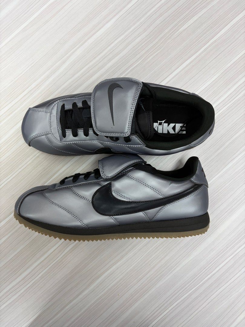 Nike Cortez SE Metallic Cool Grey / Black 72 (Category: Sneakers) located in Makati City. Submitted by sonnybau (Listing ID 1465839507, Image 2). Description: - Colorway: Metallic silver upper with black swoosh, laces, and outsole - Design: Distinct fold-over lace cover with embossed Nike branding and number 72 on the left heel panel - Sole: Gum zigzag tread for added grip and a striking look - Condition: Clean interior lining with original paper
