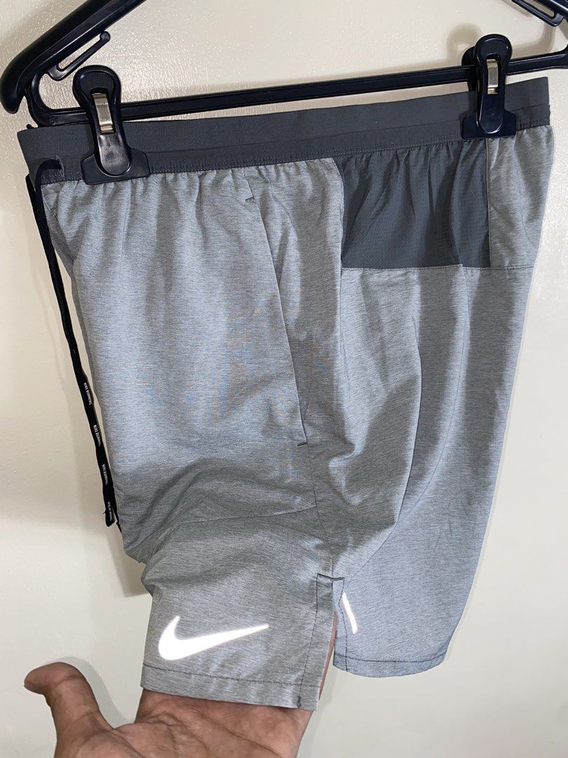 Nike Dri-FIT Grey Running Shorts Size S (Category: Shorts) located in Cebu City. Submitted by theloose.thread (Listing ID 1465919619, Image 3). Description: - Brand: Nike - Item: Men's Running Shorts - Size: Small - Color: Grey - Material: Dri-FIT moisture-wicking fabric - Features: Adjustable drawstring waist with Nike branding, side pockets, and back mesh pocket - Safety: Reflective Nike swoosh logo on the lower leg - Origin: Made in Cambodia.