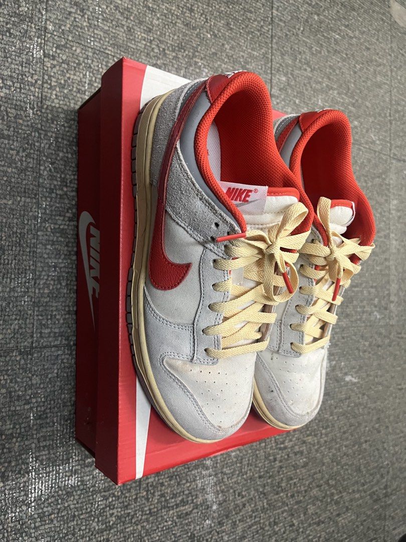 Nike Dunk Low Retro Athletic Dept (Category: Sneakers) located in Manila. Submitted by silentrabbit_8bb469 (Listing ID 1465945615, Image 2). Description: Nike Dunk Low in grey, red, and off-white with cream laces and red tips. Features 'Athletic Dept' insoles and grey outsoles with light dirt from wear. Includes the original Nike red box. Great daily beaters!.