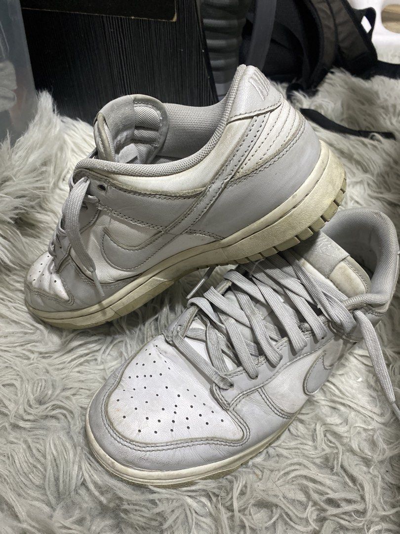 Nike Dunk Low White Grey Sneakers (Category: Sneakers) located in Manila. Submitted by cyyruss (Listing ID 1465849443, Image 1). Description: SLIGHT NEGOTIABLE - Brand: Nike - Style: Low-top sneakers / Classic Dunk design - Color: White and grey with matching laces - Features: Perforated toe box, stitched panels, and comfortable padded collar - Condition: Shows overall regular use with midsole yellowing and solid rubber outsoles - Status: Still g