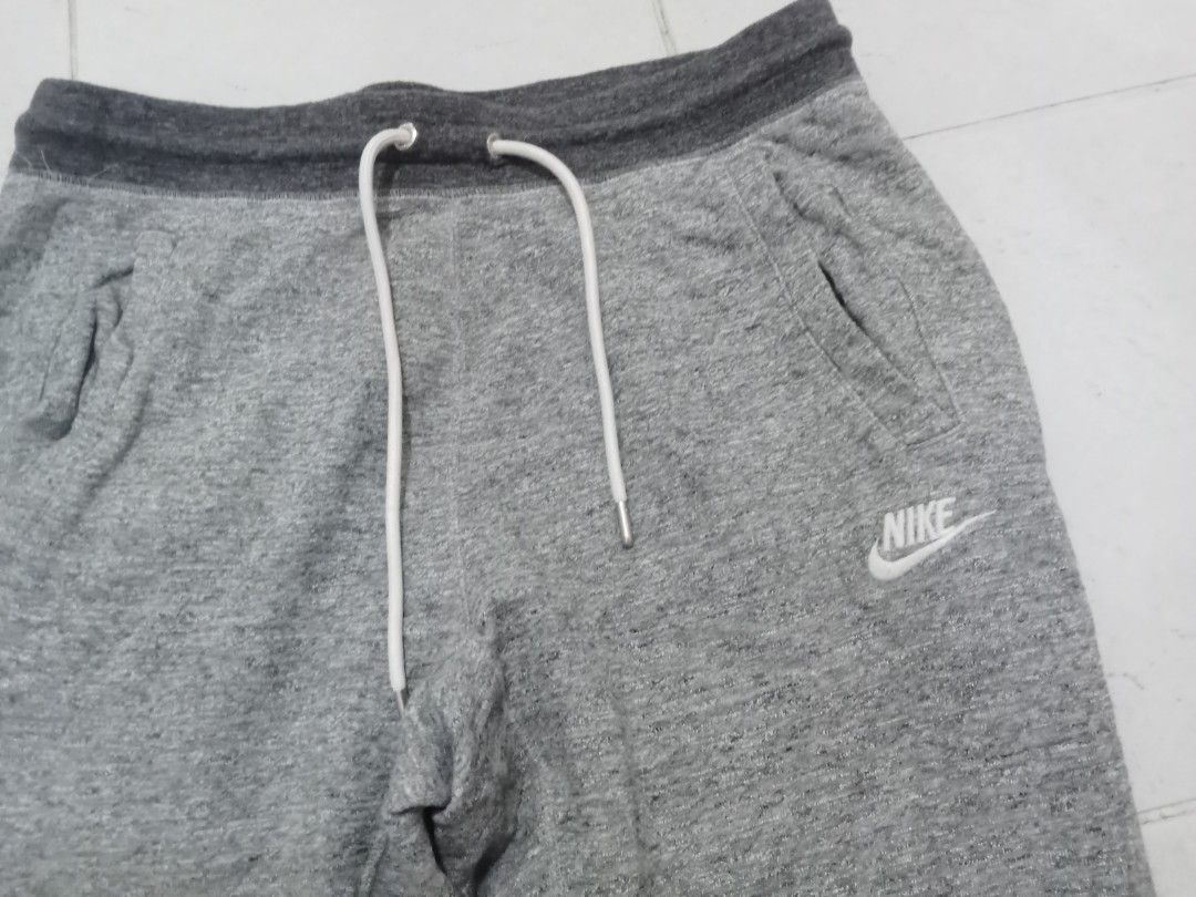 Nike Grey Fleece Sweatpants Size XL (Category: Joggers) located in Manila. Submitted by kitkathrift (Listing ID 1465869913, Image 2). Description: - Brand: Nike - Item: Fleece Sweatpants - Color: Grey with dark grey waistband and ankle cuffs - Size: XL - Details: White drawstring closure, two side pockets, and embroidered white Nike logo on the left leg - Origin: Made in China - Condition: Excellent, ready to wear.