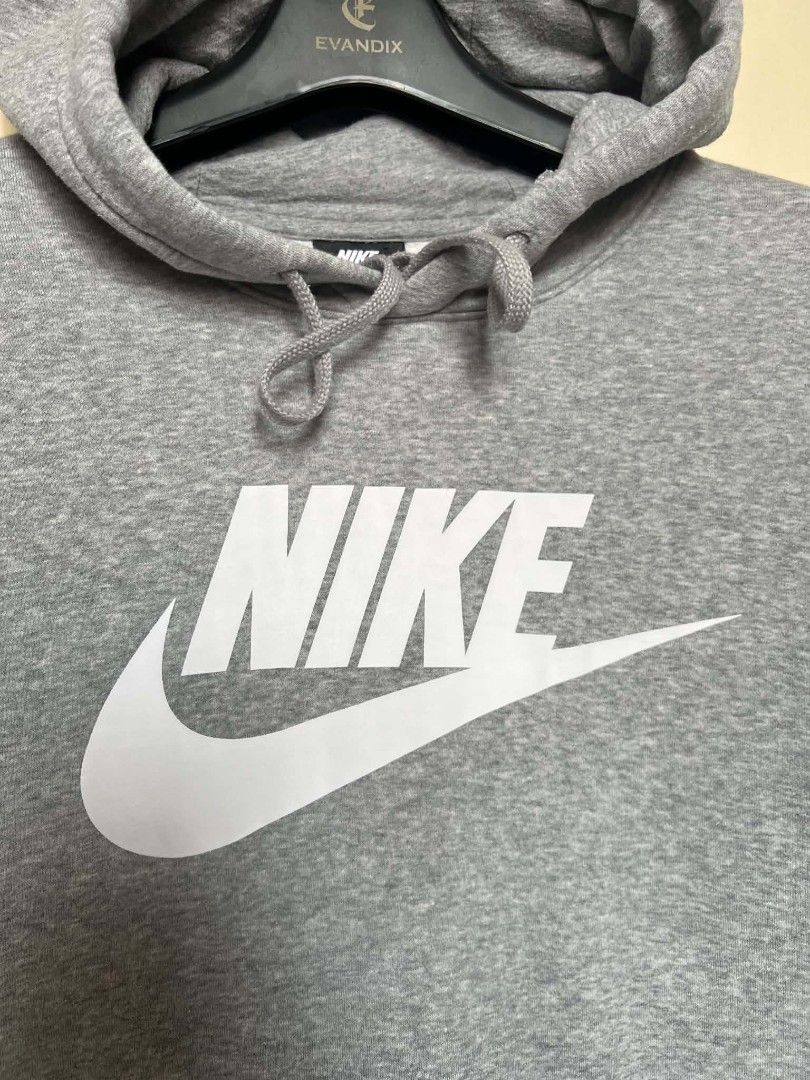 Nike Grey Logo Hoodie (Category: Hoodies) located in Manila. Submitted by granddeer.e3803b (Listing ID 1465821915, Image 2). Description: - Authentic grey Nike pullover hoodie - Features a large white swoosh and lettering on the chest - Adjustable drawstring hood and front kangaroo pocket - Ribbed cuffs and hem for a snug fit - Clean condition, well-maintained, from a smoke-free home.