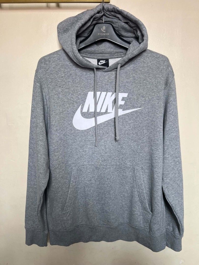Nike Grey Logo Hoodie (Category: Hoodies) located in Manila. Submitted by granddeer.e3803b (Listing ID 1465821915, Image 1). Description: - Authentic grey Nike pullover hoodie - Features a large white swoosh and lettering on the chest - Adjustable drawstring hood and front kangaroo pocket - Ribbed cuffs and hem for a snug fit - Clean condition, well-maintained, from a smoke-free home.