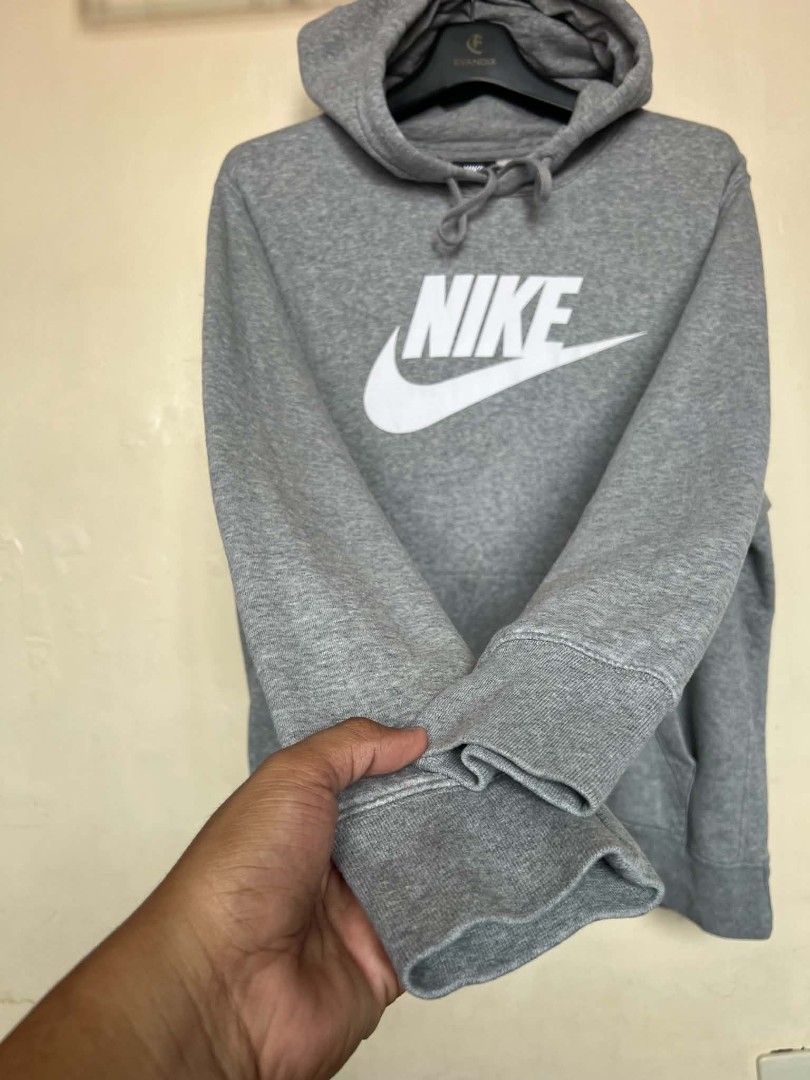 Nike Grey Logo Hoodie (Category: Hoodies) located in Manila. Submitted by granddeer.e3803b (Listing ID 1465821915, Image 3). Description: - Authentic grey Nike pullover hoodie - Features a large white swoosh and lettering on the chest - Adjustable drawstring hood and front kangaroo pocket - Ribbed cuffs and hem for a snug fit - Clean condition, well-maintained, from a smoke-free home.
