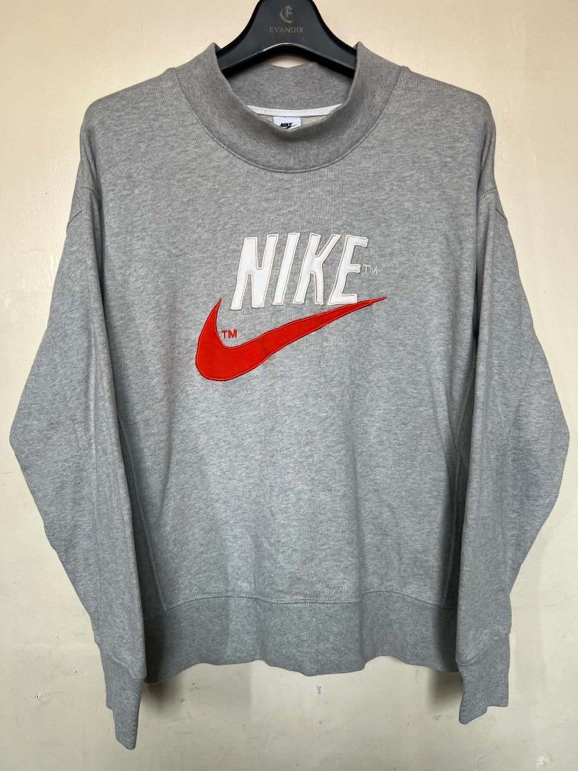 Nike Grey Mock Neck Embroidered Logo Sweatshirt (Category: Coats, Jackets and Outerwear) located in Manila. Submitted by granddeer.e3803b (Listing ID 1465831620, Image 1). Description: - Brand: Nike - Style: Mock neck sweatshirt with a nice boxy fit - Color: Grey with a big white and red embroidered chest logo (includes TM marks) - Material: Thick, clean fabric with good structure - Details: Ribbed cuffs and hem for extra durability - Condition: 