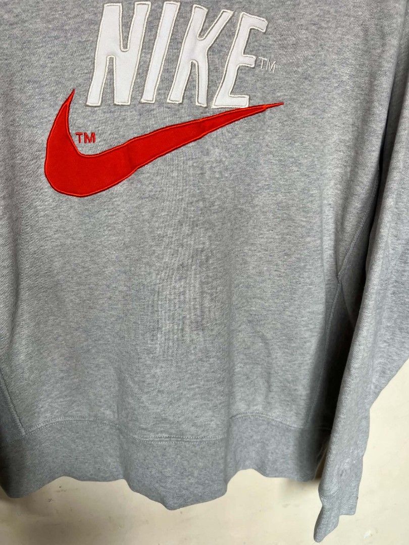 Nike Grey Mock Neck Embroidered Logo Sweatshirt (Category: Coats, Jackets and Outerwear) located in Manila. Submitted by granddeer.e3803b (Listing ID 1465831620, Image 3). Description: - Brand: Nike - Style: Mock neck sweatshirt with a nice boxy fit - Color: Grey with a big white and red embroidered chest logo (includes TM marks) - Material: Thick, clean fabric with good structure - Details: Ribbed cuffs and hem for extra durability - Condition: 