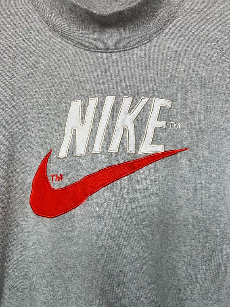 Nike Grey Mock Neck Embroidered Logo Sweatshirt (Category: Coats, Jackets and Outerwear) located in Manila. Submitted by granddeer.e3803b (Listing ID 1465831620, Image 2). Description: - Brand: Nike - Style: Mock neck sweatshirt with a nice boxy fit - Color: Grey with a big white and red embroidered chest logo (includes TM marks) - Material: Thick, clean fabric with good structure - Details: Ribbed cuffs and hem for extra durability - Condition: 