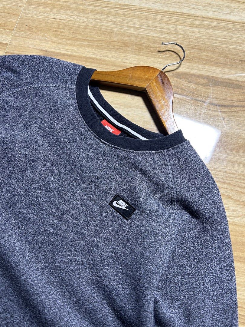 Nike Heather Grey Sweatshirt Size M (Category: Coats, Jackets and Outerwear) located in Tarlac. Submitted by selfmade_legacy (Listing ID 1465894134, Image 2). Description: - Brand: Nike - Style: Crewneck Sweatshirt (Style Code: 727394-010) - Color: Heather Grey with black ribbed cuffs, collar, and hem - Size: Medium (M) - Material: 70% cotton, 30% polyester blend - Details: Small stitched Nike patch logo on left chest - Condition: Clean fabric, n