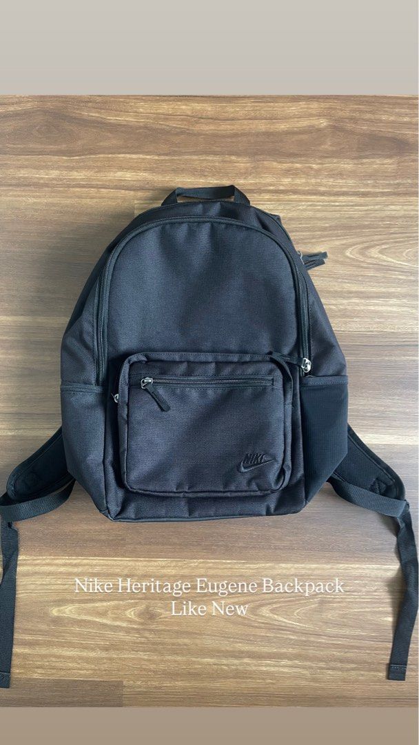 Nike Heritage Eugene Backpack (Category: Backpacks) located in Bacolod City. Submitted by jmcercado (Listing ID 1465925856, Image 1). Description: - Brand: Nike (Heritage Eugene model) - Color: Sleek All-Black with minimal embroidered branding - Storage: Spacious main zippered compartment + smaller front accessory pocket - Hydration: Convenient side bottle holders - Comfort: Adjustable padded shoulder straps - Condition: Excellent, clean inside a