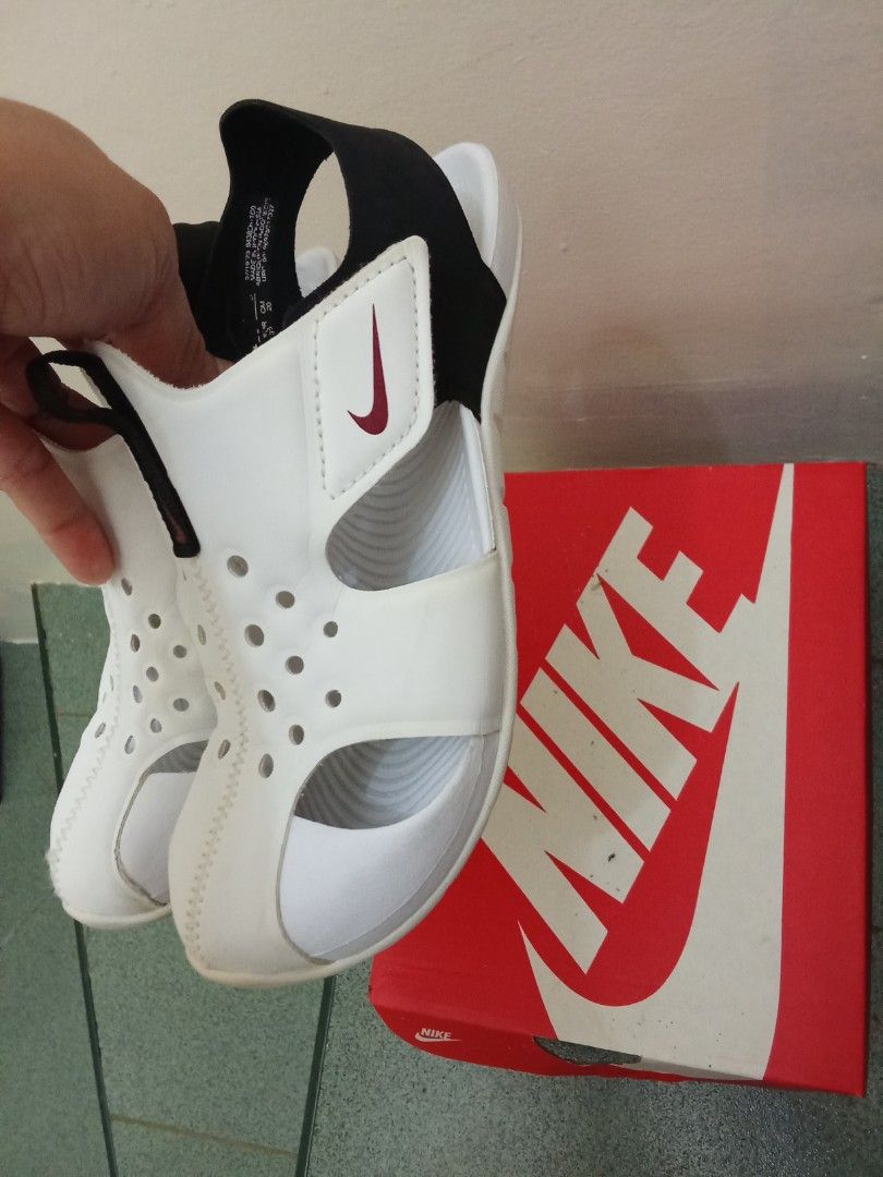 Nike Sunray Protect 2 PS White Black Sandals (Category: Babies & Kids Fashion) located in Milaor. Submitted by gffoncarousel (Listing ID 1465776543, Image 2). Description: - Authentic Nike Sunray Protect 2 sandals for kids - Classic white and black colorway - Closed-toe design with ventilation holes for breathability - Adjustable velcro side and back heel straps for a secure fit - Clean soles with barely any wear - Comes with original Nike shoebo