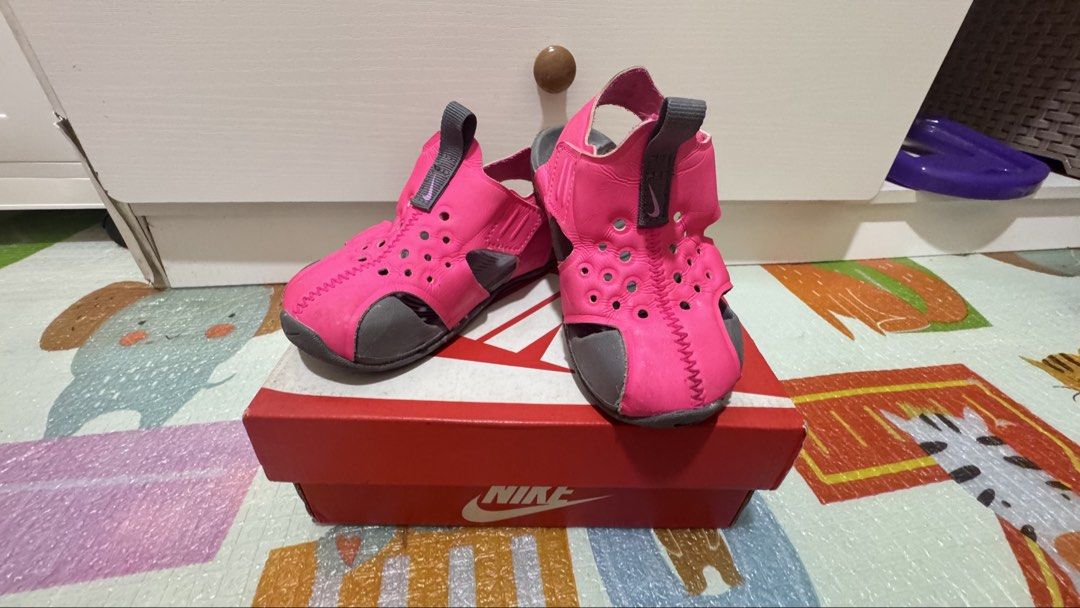 Nike Sunray Protect 2 (TD) Hyper Pink 6c (Category: Babies & Kids Fashion) located in Manila. Submitted by mcjge (Listing ID 1465926586, Image 1). Description: - Brand: Nike Toddler Sandals - Color: Hyper Pink and Grey - Style Code: 943827-605 - Size: US 6C / UK 5.5 / EUR 22 / CM 12 - Features: Great water shoes with protective toe coverage and easy Velcro back strap - Sole: Grippy wave pattern for extra traction - Inclusions: Original shoebox in