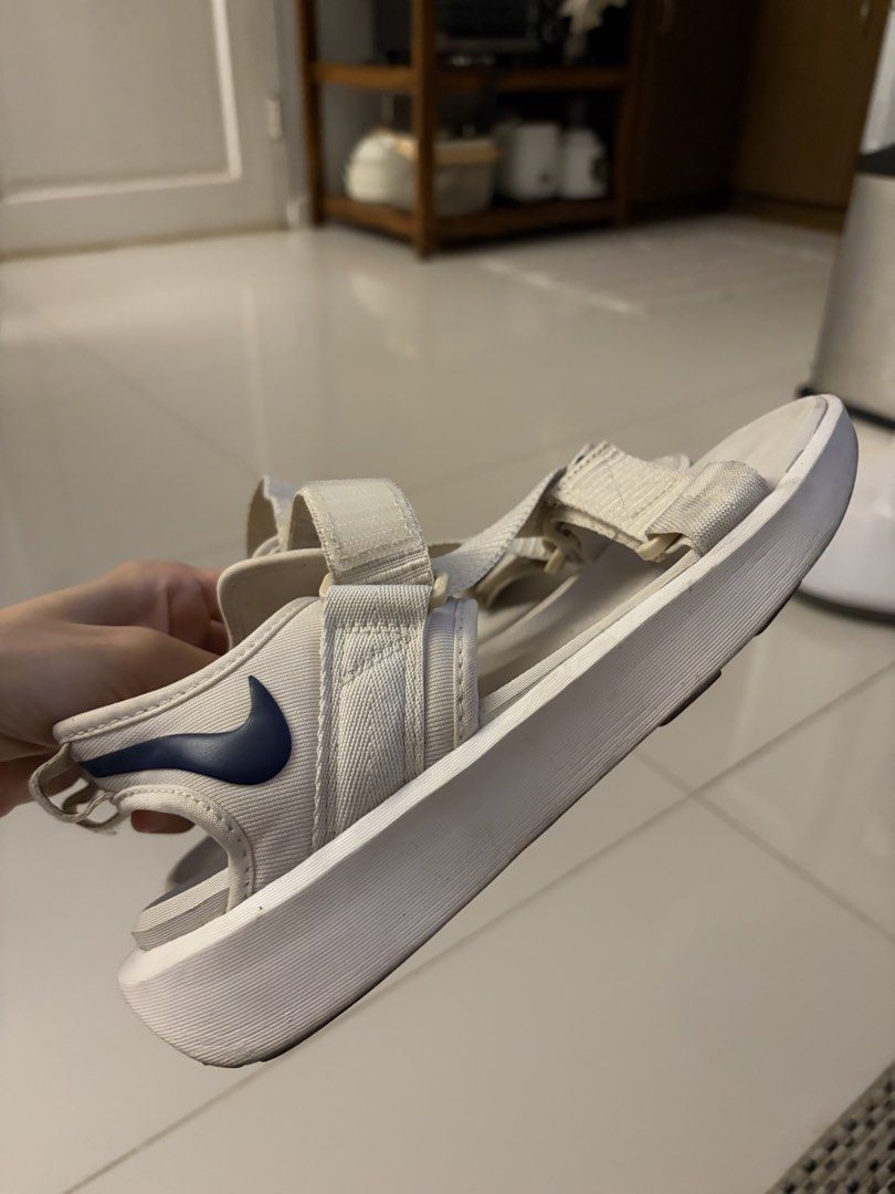 Nike White Sandals (Category: Flats & Sandals) located in Pasig City. Submitted by sums.chivs (Listing ID 1465912342, Image 2). Description: - Color: White with navy blue swoosh logo - Style: Open toe, thick platform sole for extra comfort - Closure: Adjustable velcro straps for easy on and off - Ideal for: Casual walking, daily wear, or beach trips RFS: Too small.