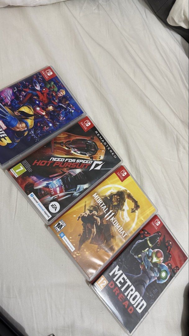 Nintendo Switch with Games and Case Bundle (Category: Nintendo) located in Valenzuela. Submitted by alexinelg (Listing ID 1465920108, Image 3). Description: - Complete Nintendo Switch console setup, ready for immediate play - Includes extra red Joy-Con controllers and black grip attachment - Official black carry case included for easy travel - 7 physical game cartridges included: * Mario Kart 8 Deluxe * Super Mario Party * Fitness Boxing * Marvel