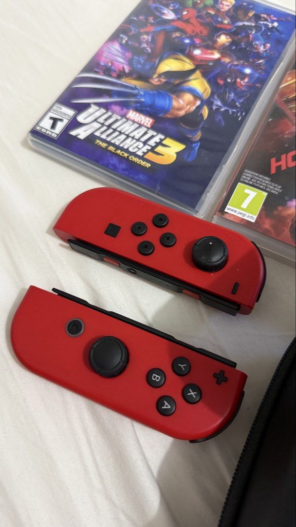 Nintendo Switch with Games and Case Bundle (Category: Nintendo) located in Valenzuela. Submitted by alexinelg (Listing ID 1465920108, Image 2). Description: - Complete Nintendo Switch console setup, ready for immediate play - Includes extra red Joy-Con controllers and black grip attachment - Official black carry case included for easy travel - 7 physical game cartridges included: * Mario Kart 8 Deluxe * Super Mario Party * Fitness Boxing * Marvel