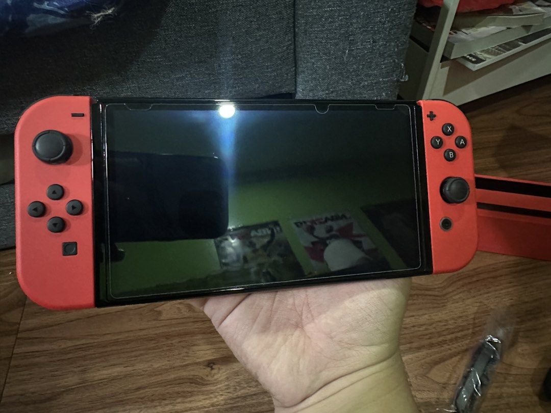 Nintendo Switch OLED Model Mario Red Edition (Category: Nintendo) located in Quezon City. Submitted by lebroncarlo23 (Listing ID 1465777957, Image 2). Description: For meetup only: Intramuros area or Commonwealth - No games included - Authentic Nintendo Switch OLED Mario Red Edition console - Includes vibrant red console, dock, Joy-Cons, grip, and two wrist straps - Comes with a matching protective carrying case - Original box included - Super cl