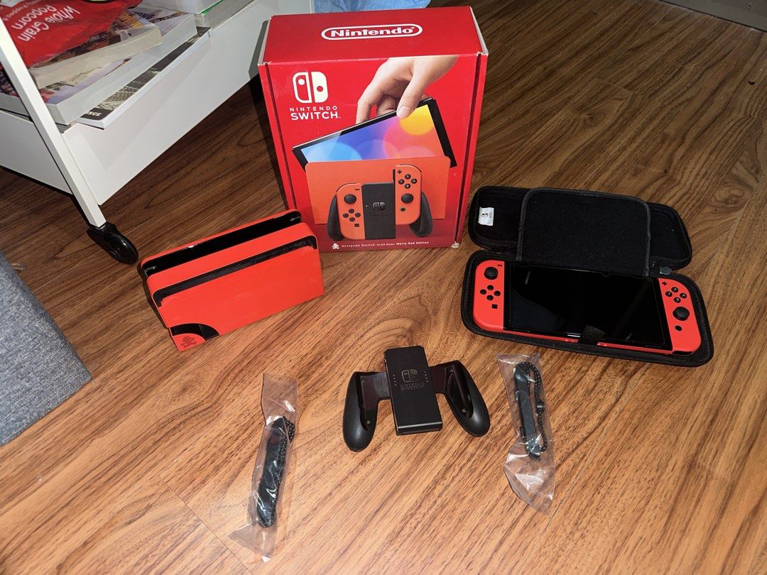 Nintendo Switch OLED Model Mario Red Edition (Category: Nintendo) located in Quezon City. Submitted by lebroncarlo23 (Listing ID 1465777957, Image 1). Description: For meetup only: Intramuros area or Commonwealth - No games included - Authentic Nintendo Switch OLED Mario Red Edition console - Includes vibrant red console, dock, Joy-Cons, grip, and two wrist straps - Comes with a matching protective carrying case - Original box included - Super cl