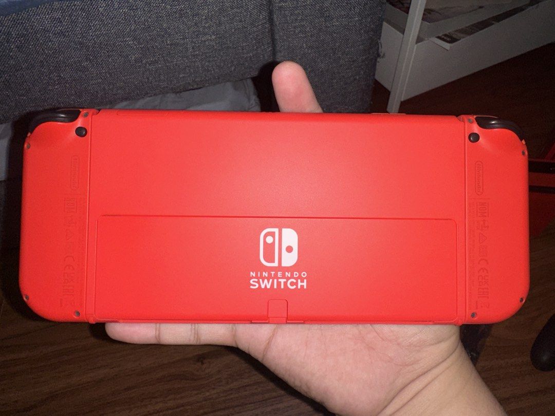 Nintendo Switch OLED Model Mario Red Edition (Category: Nintendo) located in Quezon City. Submitted by lebroncarlo23 (Listing ID 1465777957, Image 3). Description: For meetup only: Intramuros area or Commonwealth - No games included - Authentic Nintendo Switch OLED Mario Red Edition console - Includes vibrant red console, dock, Joy-Cons, grip, and two wrist straps - Comes with a matching protective carrying case - Original box included - Super cl