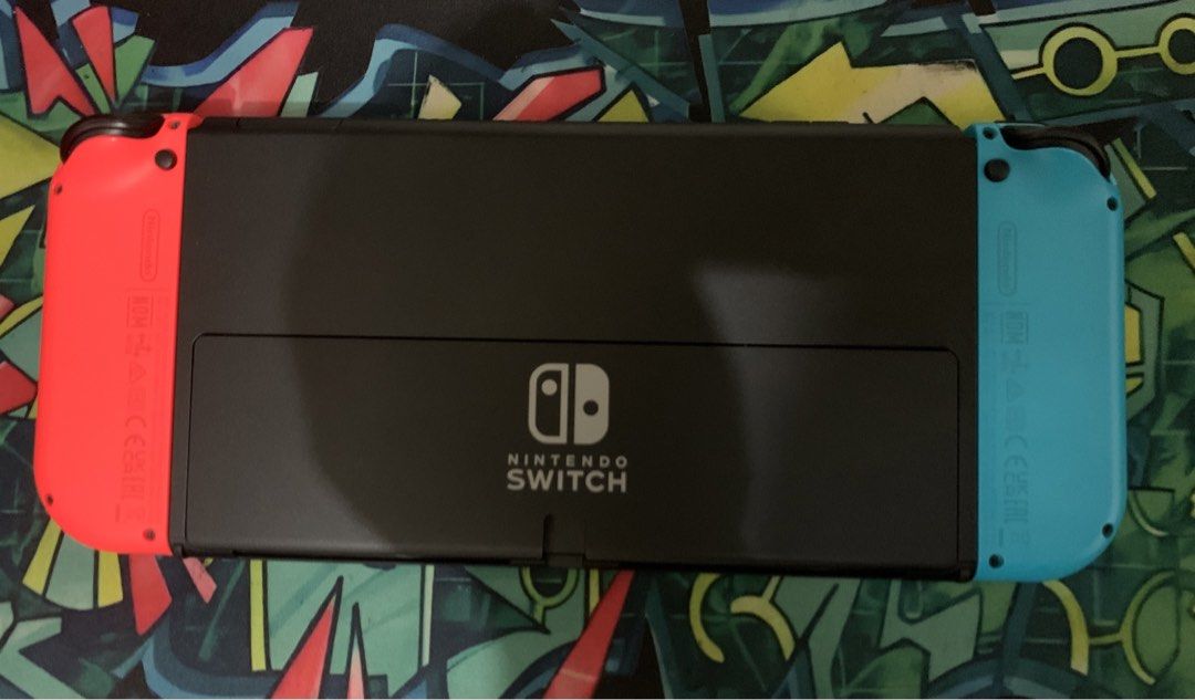Nintendo Switch Oled Neon Blue/Red (Category: Nintendo) located in Taytay. Submitted by tropamon_tcg (Listing ID 1465904149, Image 2). Description: - Nintendo Switch Oled Console with Neon Blue and Neon Red Joy-Cons - Includes original box and all standard accessories (dock, grip, power adapter, HDMI cable) - Bundled with 3 physical game cartridges: NBA 2K25, World War Z, and Street Fighter 30th Anniversary Collection - Tested and working. No iss