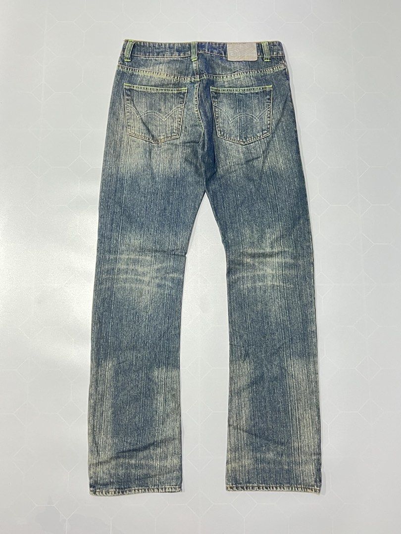 Number (N)ine Distressed Denim Jeans (Category: Jeans) located in Caloocan City. Submitted by lostarchive_55 (Listing ID 1465915088, Image 2). Description: - Brand: Number (N)ine - Wash: Blue acid wash with subtle fading - Details: Neon green accent stitching on waistband and pockets - Fit: Classic straight leg - Hardware: Branded button closure and interior waist label - Style: Standard five-pocket design with back pocket detailing - Condition: 