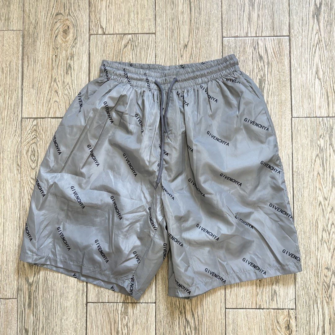 Nylon Beach Board Shorts (Category: Shorts) located in Imus. Submitted by reloved.nd (Listing ID 1465812112, Image 1). Description: - Brand: Givenchy - Color: Grey - Material: Lightweight nylon - Design: All-over repeated logo print - Waistband: Elastic with adjustable drawstring - Fit: Standard fit, easy slip-on style - Condition: Excellent - Perfect for: Casual wear, streetwear, or beach trips.