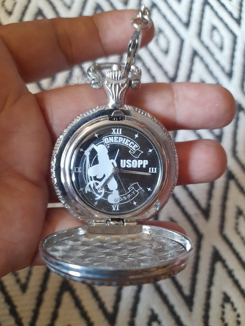 One Piece Usopp Pocket Watch with Chain (Category: Men's Watches) located in Bocaue. Submitted by marajapansurplus (Listing ID 1465788680, Image 1). Description: - Selling g as it is - untested, need battery replacement - Silver-tone pocket watch featuring One Piece character Usopp - Black dial face with classic Roman numerals and analog quartz movement - Detailed anime motif on the front cover - Includes a matching chain and convenient belt clip