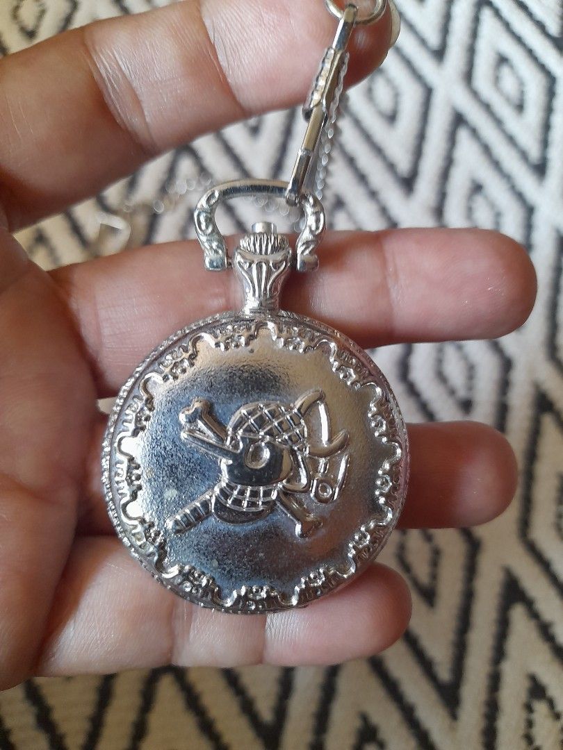 One Piece Usopp Pocket Watch with Chain (Category: Men's Watches) located in Bocaue. Submitted by marajapansurplus (Listing ID 1465788680, Image 3). Description: - Selling g as it is - untested, need battery replacement - Silver-tone pocket watch featuring One Piece character Usopp - Black dial face with classic Roman numerals and analog quartz movement - Detailed anime motif on the front cover - Includes a matching chain and convenient belt clip