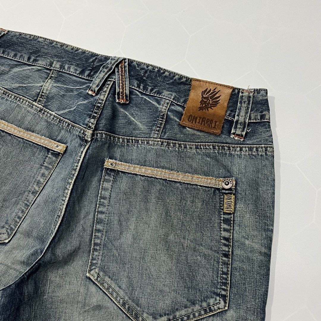 Oniarai Distressed Denim Shorts (Category: Shorts) located in Caloocan City. Submitted by lostarchive_55 (Listing ID 1465918514, Image 3). Description: - Brand: Oniarai - Style: Distressed blue denim shorts / Casual streetwear - Details: Heavily washed finish, factory distressing, and subtle whiskering - Hem: Frayed cut-off hems - Graphic: Unique skull embroidery on the left leg - Hardware & Branding: Branded metal hardware, leather back patch, a