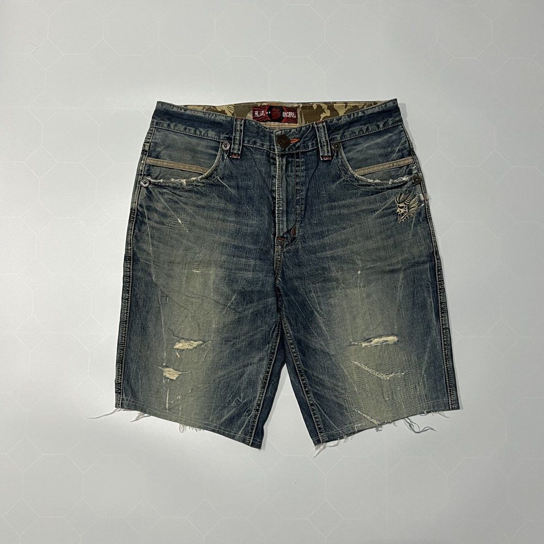 Oniarai Distressed Denim Shorts (Category: Shorts) located in Caloocan City. Submitted by lostarchive_55 (Listing ID 1465918514, Image 2). Description: - Brand: Oniarai - Style: Distressed blue denim shorts / Casual streetwear - Details: Heavily washed finish, factory distressing, and subtle whiskering - Hem: Frayed cut-off hems - Graphic: Unique skull embroidery on the left leg - Hardware & Branding: Branded metal hardware, leather back patch, a