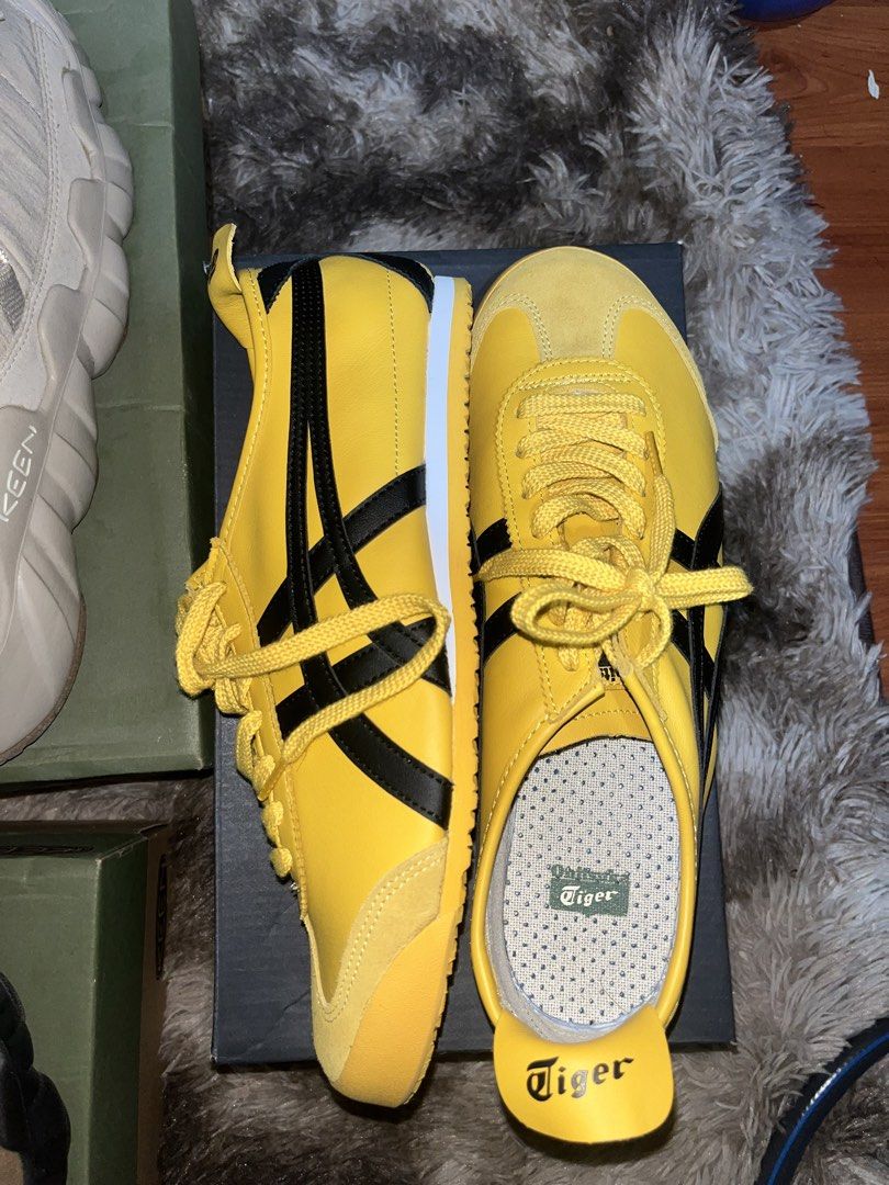 Onitsuka Tiger (kill bill) (Category: Sneakers) located in Caloocan City. Submitted by kristoperlim (Listing ID 1465836102, Image 1). Description: - Brand: Onitsuka Tiger - Color: Bright yellow with iconic black stripes and matching yellow laces - Design: Classic low-profile shape with suede toe overlay and white midsole accent - Comfort: Cushioned insoles featuring the green Tiger logo print - Details: Back heel tab with classic script Tiger bra