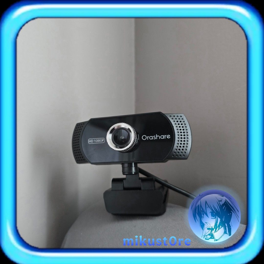 Orashare HD 1080P Webcam with Stand (Category: Webcams) located in Manila. Submitted by mikust0re (Listing ID 1465765302, Image 1). Description: - Brand/Model: Orashare 1080P HD Webcam - Color: Sleek black finish with a stylish silver lens ring - Audio: Built-in microphone with grilles on both ends for clear sound - Features: Adjustable desk clip stand attached for easy setup - Connectivity: USB cable included, true plug-and-play operation - Idea