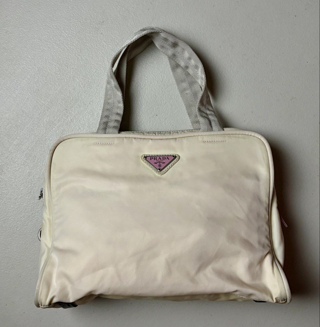 Orig Prada Nylon Handbag Cream Pink (Category: Luxury Bags & Wallets) located in Manila. Submitted by hippiesph (Listing ID 1465935650, Image 1). Description: PRADA NYLON - HAND BAG / TOTE BAG Authentic CHECK DETAILS POSTED Price: 3k + sf Dm for more details 📩.
