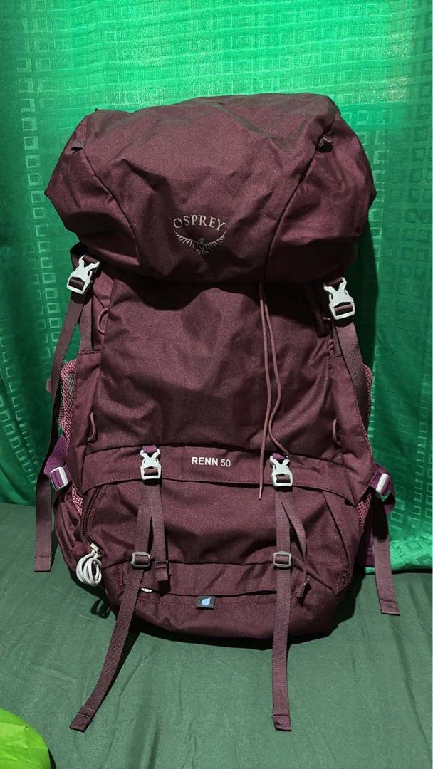 Osprey Renn 50 Backpack Maroon (Category: Backpacks) located in Tampakan. Submitted by camilleveg44134 (Listing ID 1465929827, Image 1). Description: - Brand/Model: Osprey Renn 50 Backpack - Color: Maroon with a bright green Osprey rain cover included - Capacity: Ideal for multi-day hikes and camping trips - Features: Adjustable straps, multiple secure buckle closures, and front straps - Condition: Clean fabric and sturdy zippers throughout, very