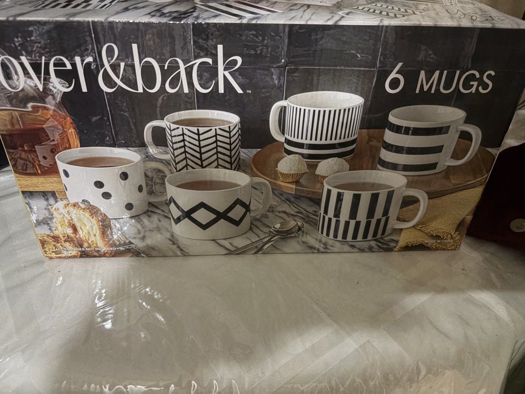 Over & Back 6 Mugs Set Black White Patterns (Category: Coffee & Tea Tableware) located in Quezon City. Submitted by din728 (Listing ID 1465838359, Image 1). Description: - Brand: Over & Back - Quantity: Set of 6 ceramic mugs - Design: Modern monochrome with assorted black and white patterns (stripes, dots, chevrons) - Ideal for: Daily coffee, tea, or as a housewarming gift - Packaging: Comes in the original printed box.