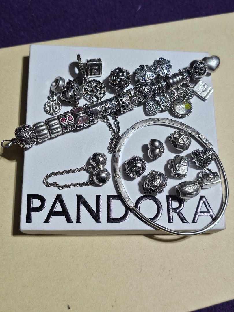 Pandora bracelet and charms (Category: Charms) located in Manila. Submitted by onlinesmartshopping12 (Listing ID 1465887308, Image 2). Description: all original mix of new and preloved but pass as new new keep safe with rosegold - 1800 new Taiwan sioma travel -2500 new loveu - 1500 preloved bangle with receipt - 3000 medical cadaceus 14k - 2500 two tone 14k family dangle - 2200 two tone 14k family - 2200 family safety chain - 2500 heart dangle 2p