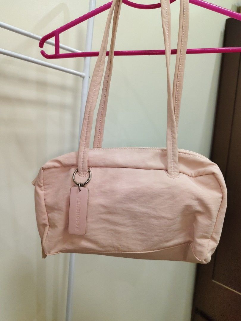 Penshoppe Pink Shoulder Bag (Category: Shoulder Bags) located in Manila. Submitted by clairevald34303 (Listing ID 1465910154, Image 3). Description: - Brand: Penshoppe - Color: Soft pink - Shape: Structured rectangle with double top handles - Closure: Secure zip closure - Interior: Matching pink fabric lining with 1 slip pocket and 1 zippered compartment - Extras: Includes matching brand tag on side hardware and silica gel packet - Condition: Cle