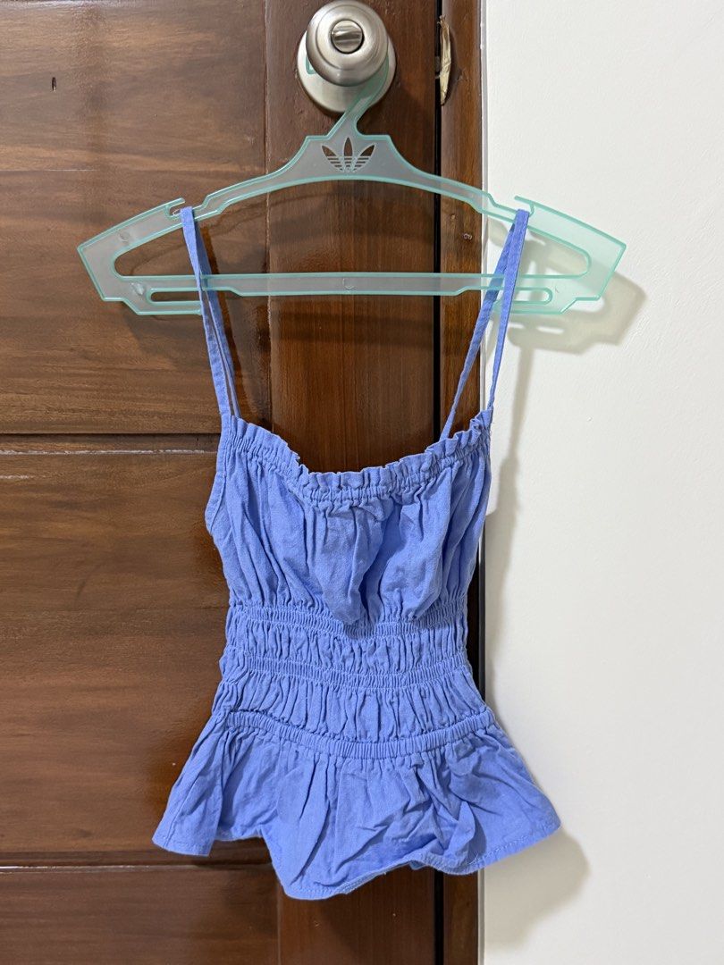 Periwinkle Blue Smocked Ruffle Strap Tank Top (Category: Sleeveless) located in Quezon City. Submitted by wishmejuu (Listing ID 1465866982, Image 1). Description: - Color: Periwinkle blue - Neckline: Square neck with soft gathering - Fit: Comfortable smocked elastic bodice - Design: Flared ruffle hem with thin adjustable spaghetti straps - Style: Casual everyday wear, great for pairing with jeans or shorts.