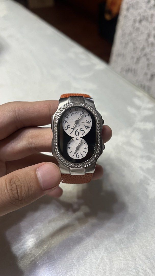 Philip Stein Dual Time Diamond (Category: Women's Watches) located in Manila. Submitted by thcappa (Listing ID 1465889570, Image 1). Description: - Brand: Philip Stein - Design: Dual time zone with distinct dual-dial layout and textured white dials - Case: Stainless steel outer bezel lined with sparkling crystals and dual side crowns - Strap: Genuine orange leather with textured lizard pattern and silver-tone logo-stamped pin buckle - Condition: 