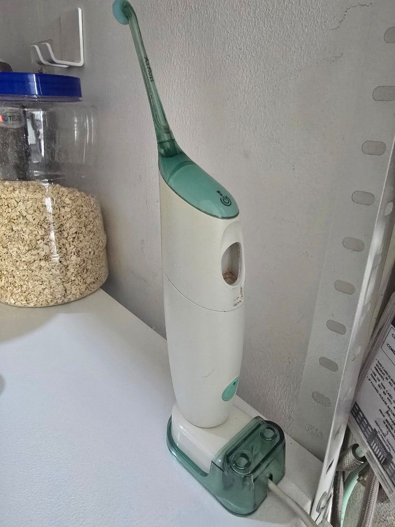 Philips Sonicare AirFloss HX8240 with Charging Base (Category: Oral Care) located in Taguig. Submitted by jollero (Listing ID 1465867697, Image 1). Description: - Item: Philips Sonicare AirFloss (Model HX8240, Assembled in Mexico) - Includes: White and green handle + matching charging base station with power cord - Power: Built-in rechargeable lithium-ion battery (powers up normally on charger) - Condition: Used, with some visible mineral buildup