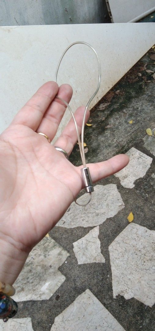 Phone strap silver transparent (Category: Everything Else Others) located in Quezon City. Submitted by eidorableshop (Listing ID 1465812245, Image 2). Description: - Material: Durable silver metal wire cable - Design: Flexible oval loop with a sliding cylindrical connector - Mechanism: Easy-to-use sliding fastening system - Use: Versatile accessory for hanging, organizing, or holding various items - Condition: Brand new and high quality.