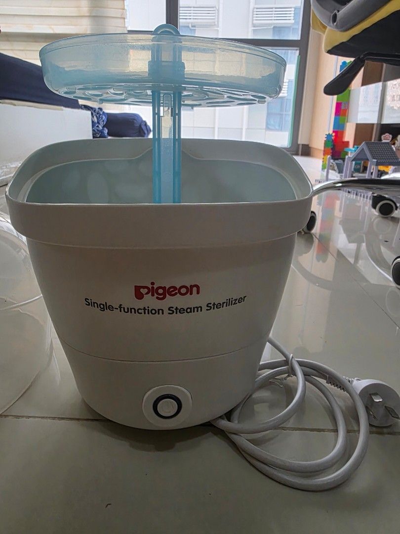 Pigeon Single-Function Steam Sterilizer (Category: Breastfeeding & Bottle Feeding) located in Taguig. Submitted by ziostore (Listing ID 1465775007, Image 3). Description: - Brand: Pigeon Single-Function Steam Sterilizer - Color/Material: White and blue compact plastic body - Condition: Powers on properly, clean heating plate with minor usage marks - Ease of Use: Simple one-button operation - Ideal For: Quick and efficient sterilization of baby bo